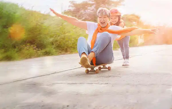 Senior and child on skateboard