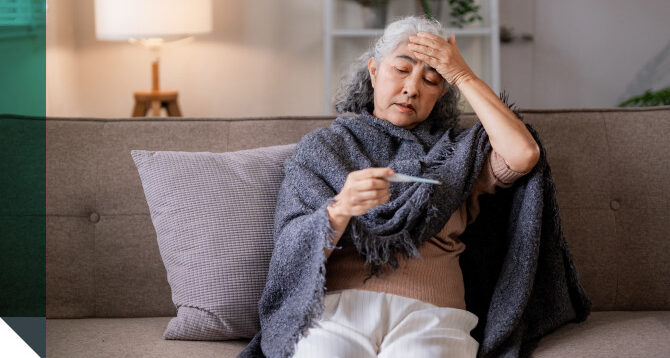 A woman checks her temperature after catching a respiratory virus.